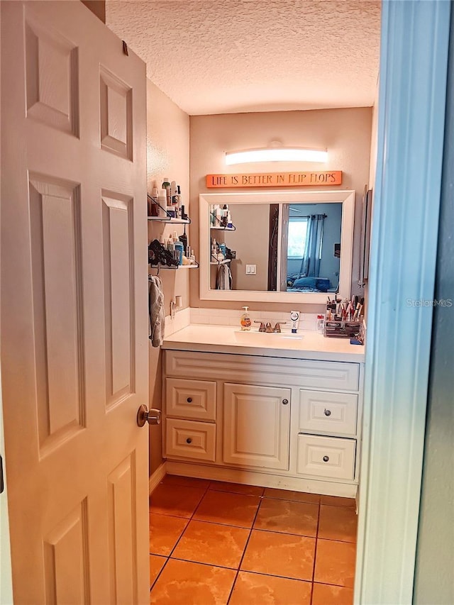 bathroom with vanity, tile patterned floors, and a textured ceiling