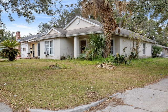 single story home with a front yard and cooling unit