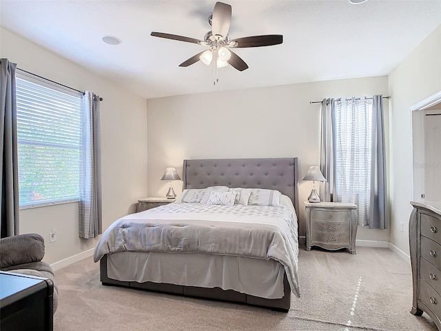 bedroom featuring light carpet and ceiling fan