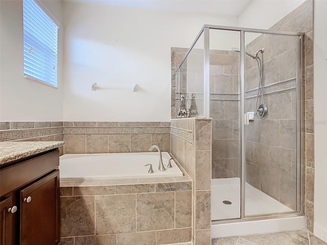 bathroom with vanity and separate shower and tub