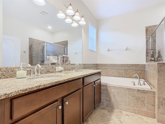 bathroom with tile patterned floors, vanity, and shower with separate bathtub