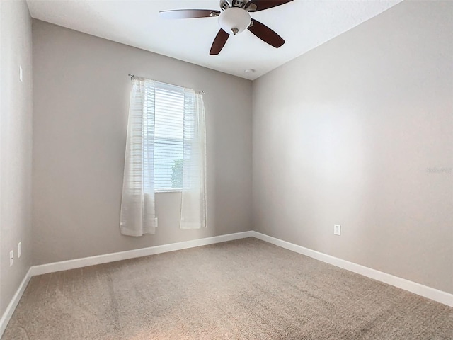 spare room featuring carpet flooring and ceiling fan