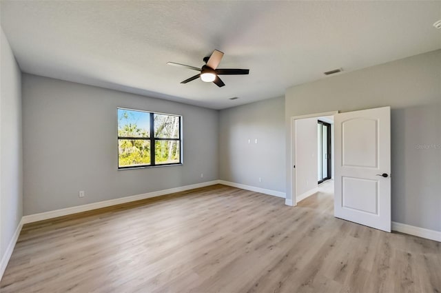 empty room with ceiling fan and light wood-type flooring