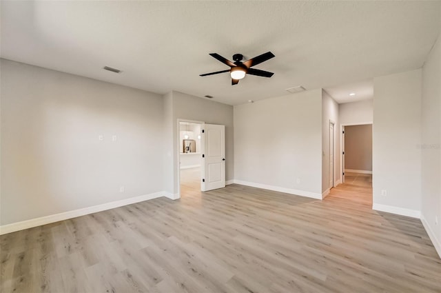 empty room featuring ceiling fan and light hardwood / wood-style floors