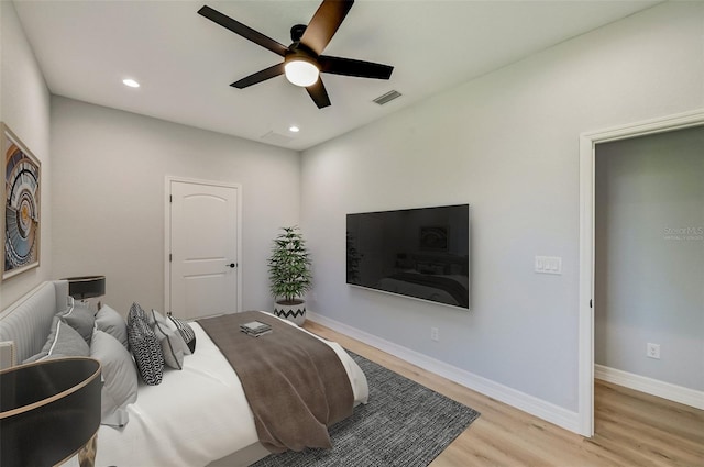 bedroom with ceiling fan and light hardwood / wood-style floors