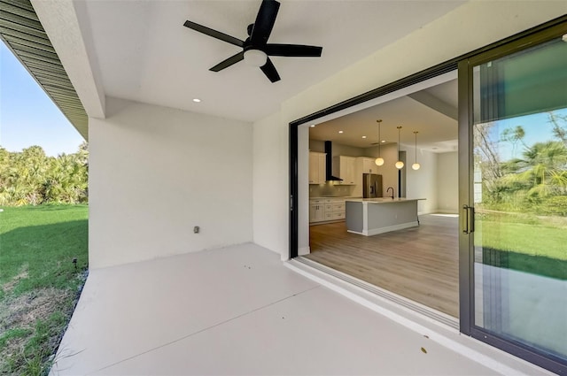 view of patio / terrace with ceiling fan and exterior kitchen