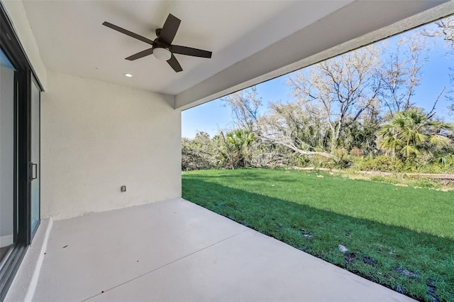 view of yard with a patio area and ceiling fan