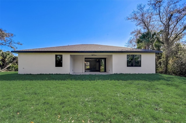 back of property featuring a patio and a yard