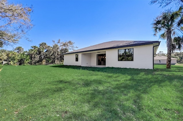 back of house with a lawn