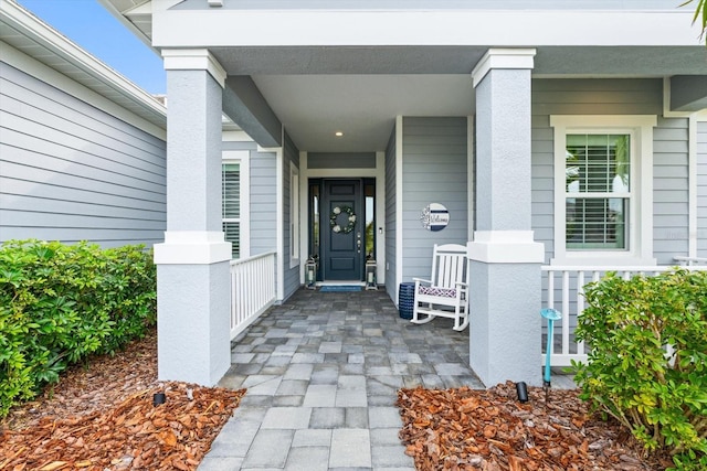 entrance to property featuring covered porch