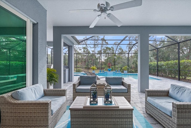 view of patio with ceiling fan, outdoor lounge area, and a lanai