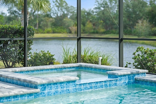 view of swimming pool with glass enclosure and a water view