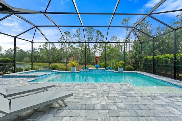 view of pool with a patio, an in ground hot tub, and glass enclosure