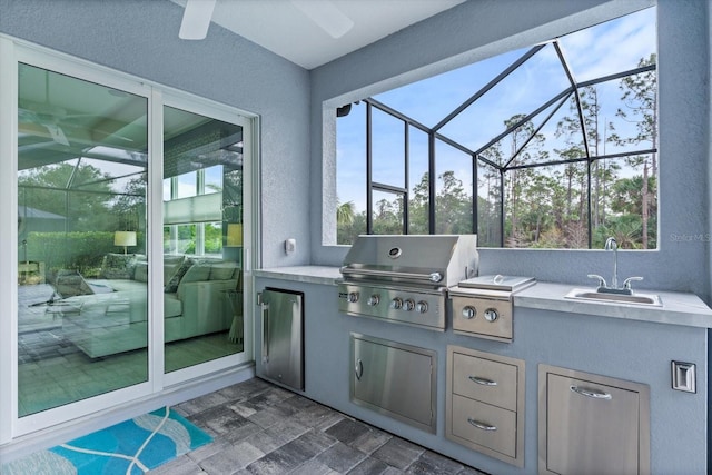 view of patio / terrace with sink, exterior kitchen, a lanai, and area for grilling