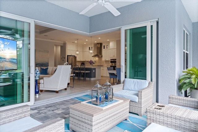 view of patio / terrace featuring ceiling fan and an outdoor living space