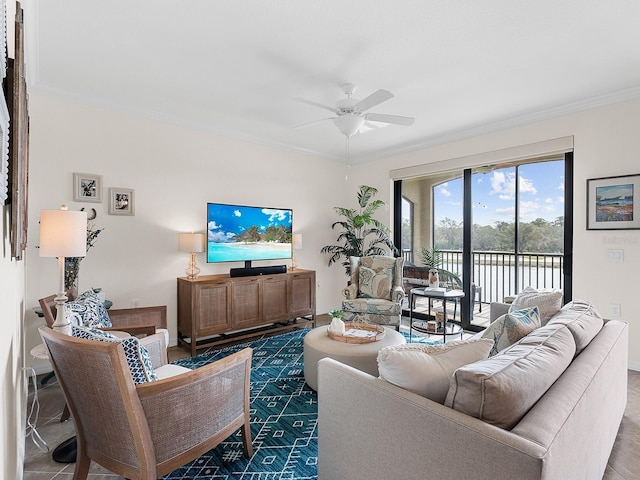 living room with ceiling fan and ornamental molding