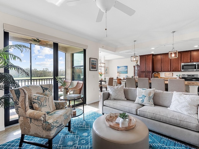 tiled living room with ceiling fan and crown molding