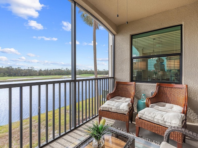 sunroom / solarium with a water view