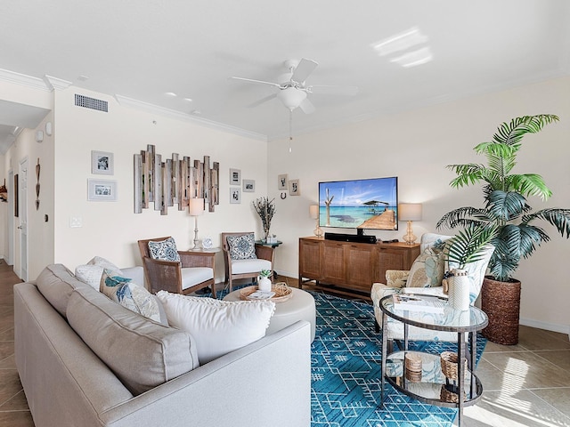 living room with ceiling fan, dark tile patterned floors, and crown molding