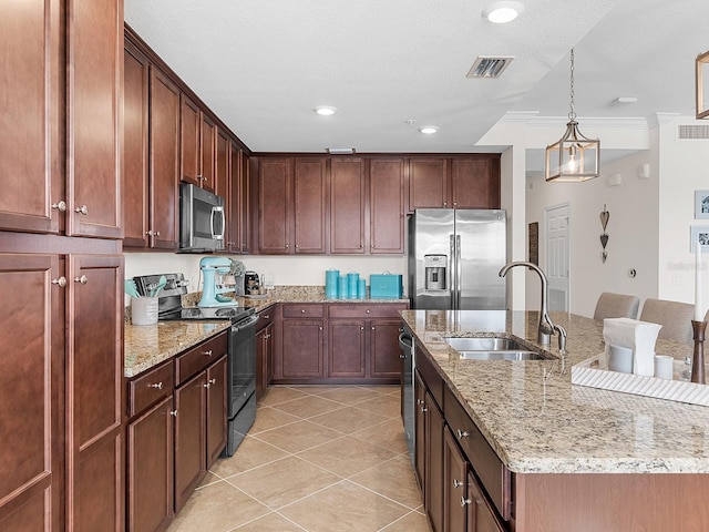 kitchen with decorative light fixtures, stainless steel appliances, an island with sink, sink, and crown molding