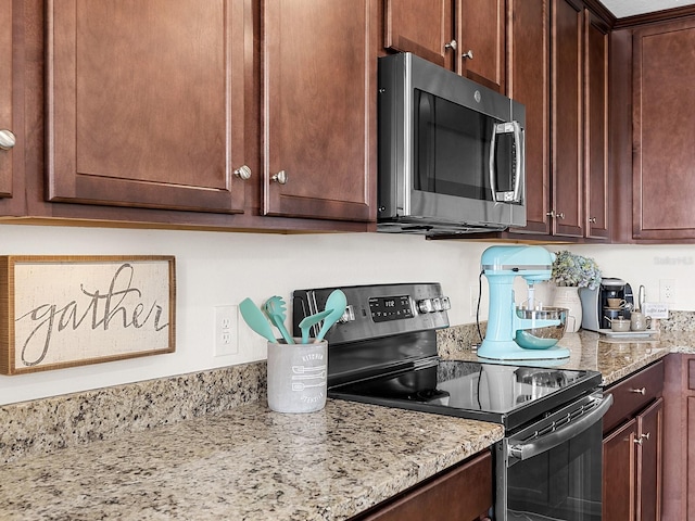 kitchen with light stone counters and stainless steel appliances