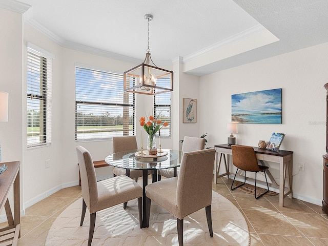 tiled dining area featuring a notable chandelier and ornamental molding