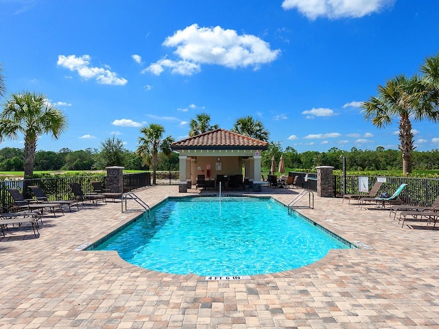 view of swimming pool featuring a patio area and a gazebo