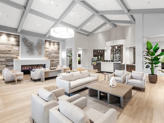 living room with light hardwood / wood-style floors, beamed ceiling, high vaulted ceiling, and bar