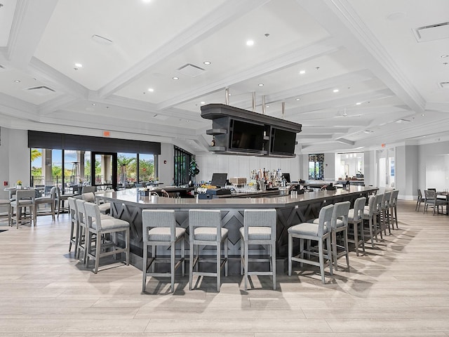 bar featuring coffered ceiling, light wood-type flooring, beam ceiling, and a wealth of natural light