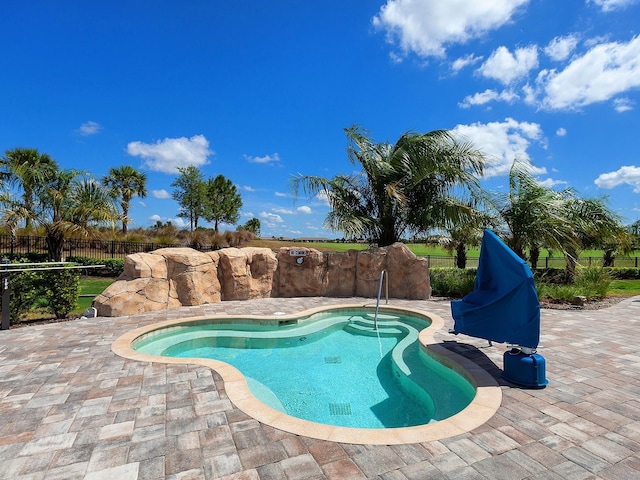 view of swimming pool with a patio area