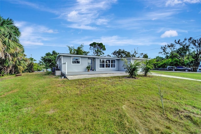 single story home with a front lawn and a patio area