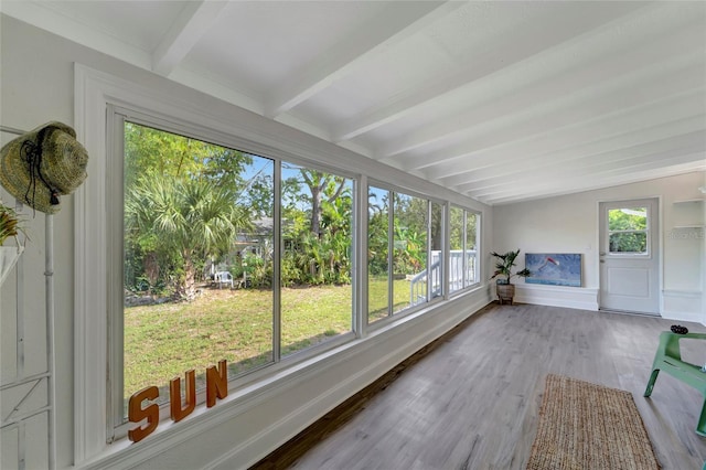 sunroom with a healthy amount of sunlight and beamed ceiling