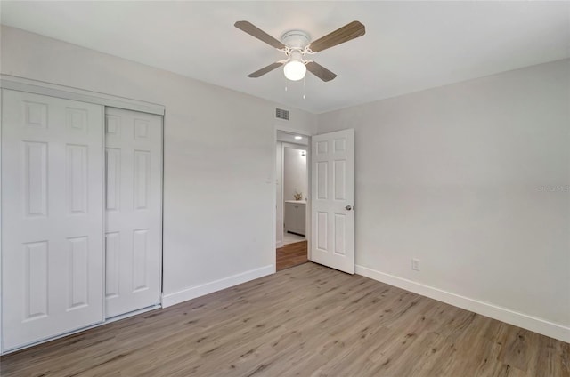 unfurnished bedroom with ceiling fan, a closet, and light hardwood / wood-style floors