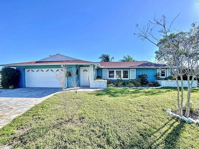 ranch-style home with a garage and a front yard