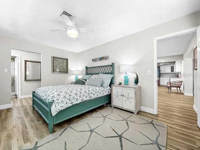 bedroom with ceiling fan and light hardwood / wood-style floors