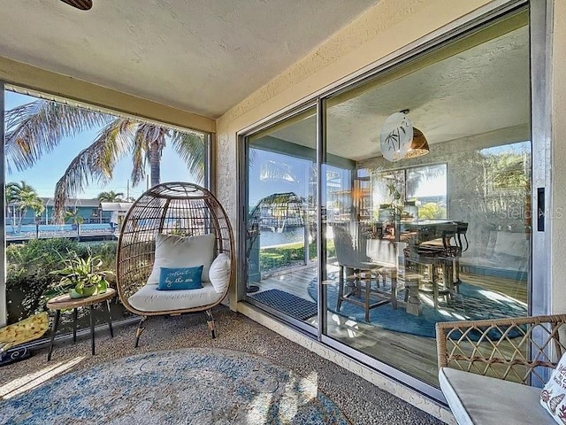 sunroom featuring plenty of natural light and a water view