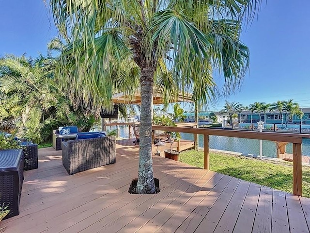 wooden terrace featuring an outdoor hangout area and a water view