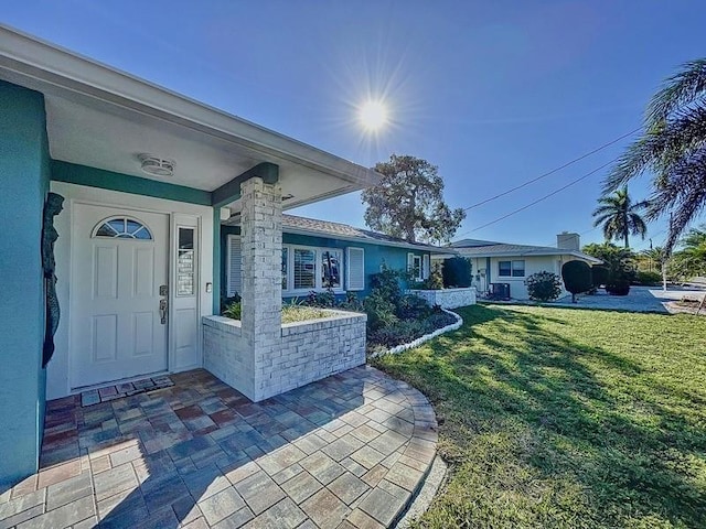 doorway to property featuring a yard