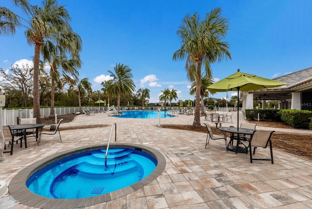 view of pool with a patio area and a hot tub