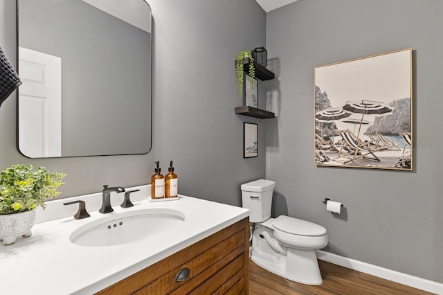 bathroom featuring hardwood / wood-style flooring, vanity, and toilet