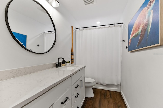 full bathroom featuring vanity, wood-type flooring, shower / bath combination with curtain, and toilet