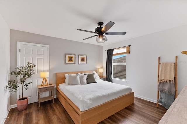 bedroom with ceiling fan and dark hardwood / wood-style flooring