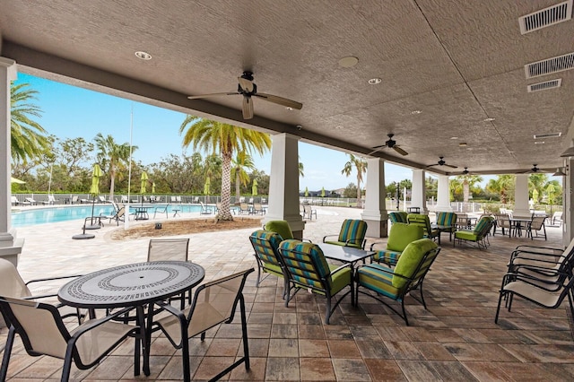 view of patio / terrace with a community pool and ceiling fan