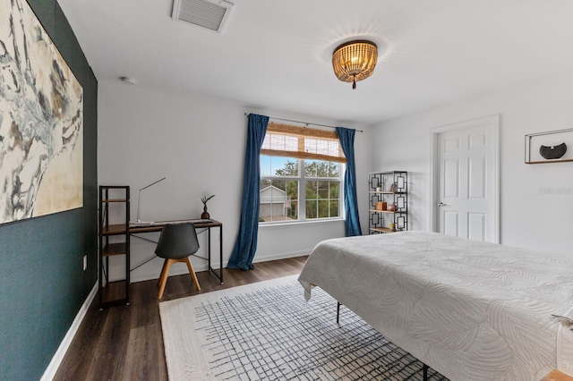 bedroom with dark hardwood / wood-style flooring