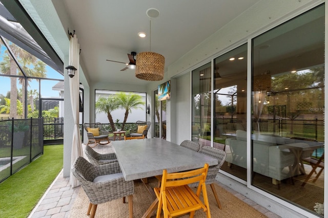 sunroom with ceiling fan