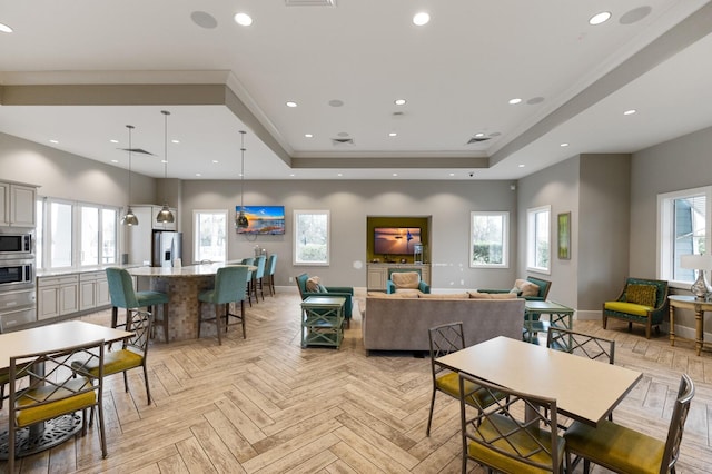 living room featuring a raised ceiling and light parquet flooring