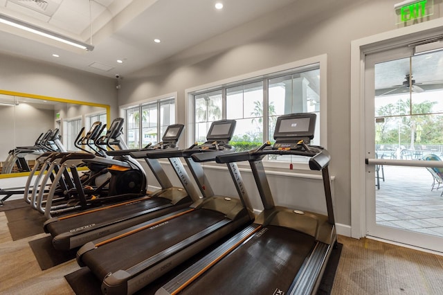 gym with ceiling fan and carpet