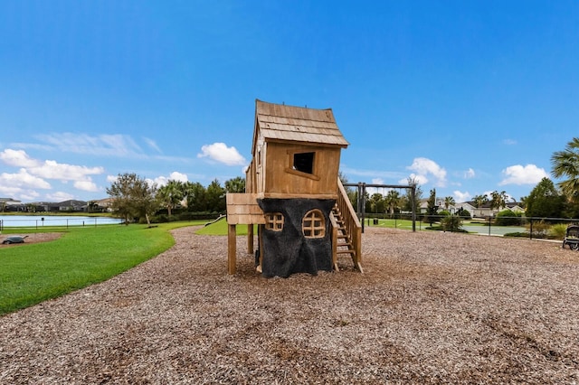 view of playground featuring a water view and a yard