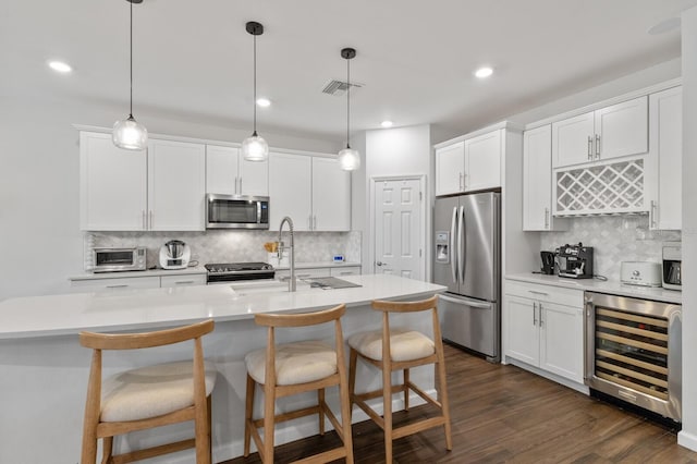 3409 Anchor Bay Trl, Lakewood Ranch, FL 34211 - kitchen with stainless steel appliances, beverage cooler, tasteful backsplash, a sink, and recessed lighting