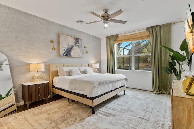 3409 Anchor Bay Trl, Lakewood Ranch, FL 34211 - bedroom featuring baseboards, wallpapered walls, a baseboard radiator, an accent wall, and wood finished floors